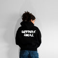Person wearing a black hoodie with 'Support Local' text on the back against a plain background