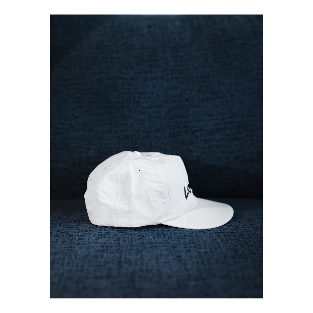 White cap on a textured dark blue background
